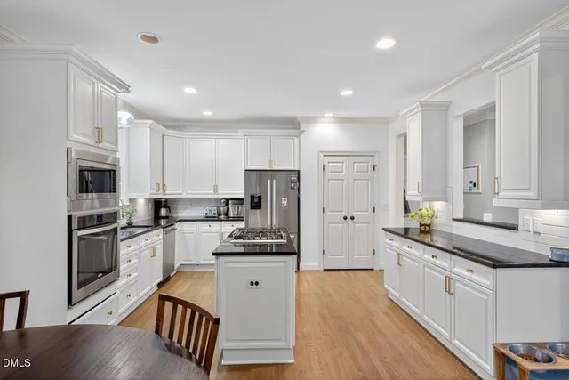 a kitchen with stainless steel appliances granite countertop a sink and cabinets