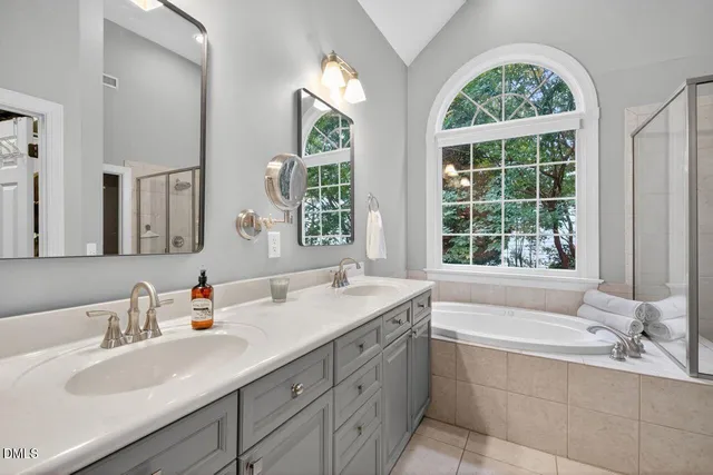 a white bath tub sitting next to a shower