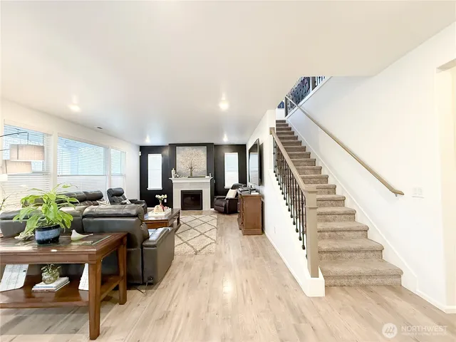 a living room with furniture and a piano
