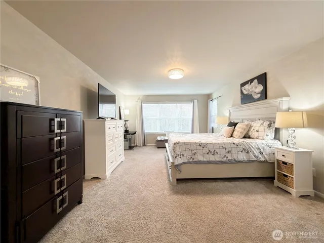 a bedroom with a bed couch and a window