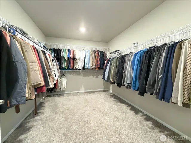 a living room with furniture kitchen view and a large window