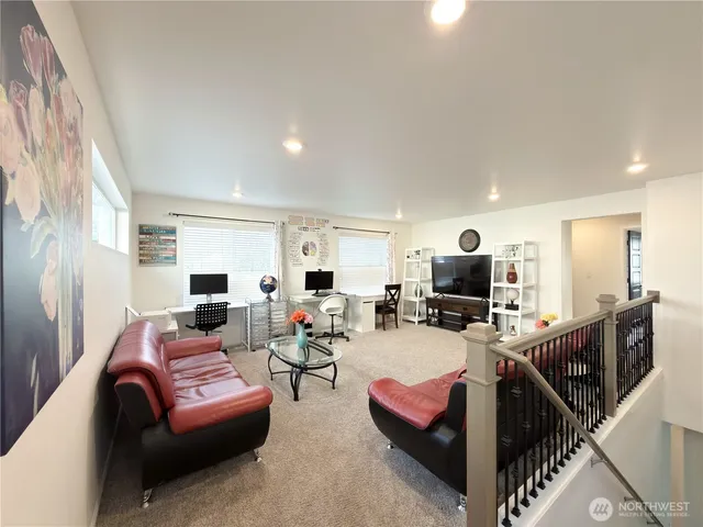 a dining room with furniture and a wooden floor
