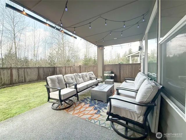 a view of a house with a yard and sitting area