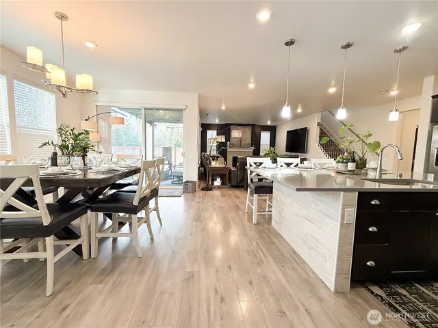 a kitchen with stainless steel appliances kitchen island granite countertop a refrigerator and a stove top oven