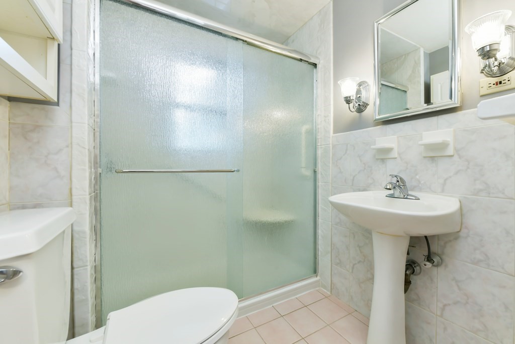 71 Paul Street Dedham, MA 02026 - Photo 18 of 22 a bathroom with a sink toilet and shower