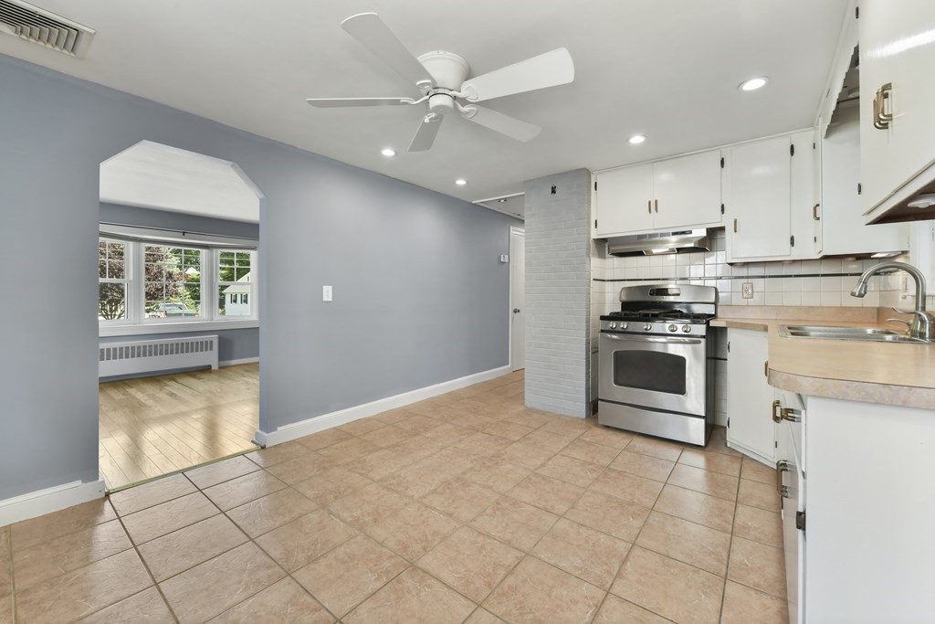 71 Paul Street Dedham, MA 02026 - Photo 10 of 22 a kitchen with stainless steel appliances granite countertop a stove sink and cabinets