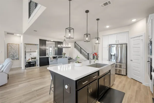 a kitchen with stainless steel appliances granite countertop a sink stove and refrigerator