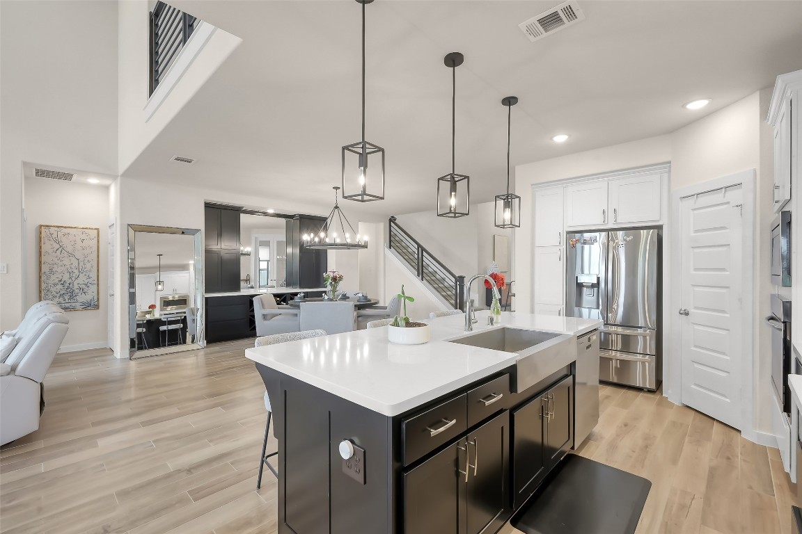 6718 Waxbill Road Katy, TX 77493 - Photo 12 of 48 a kitchen with stainless steel appliances kitchen island a refrigerator and a view of living room