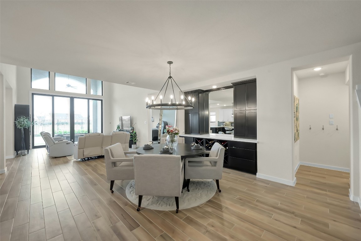 6718 Waxbill Road Katy, TX 77493 - Photo 14 of 48 a living room with furniture wooden floor and a chandelier
