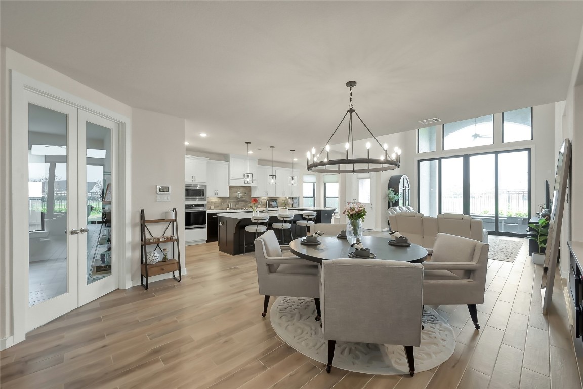 6718 Waxbill Road Katy, TX 77493 - Photo 15 of 48 a living room with couches a table and chairs with wooden floor