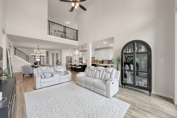 a living room with furniture a flat screen tv and a large window