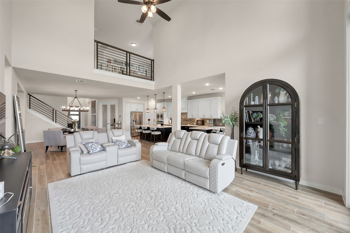 6718 Waxbill Road Katy, TX 77493 - Photo 16 of 48 a living room with furniture and a chandelier
