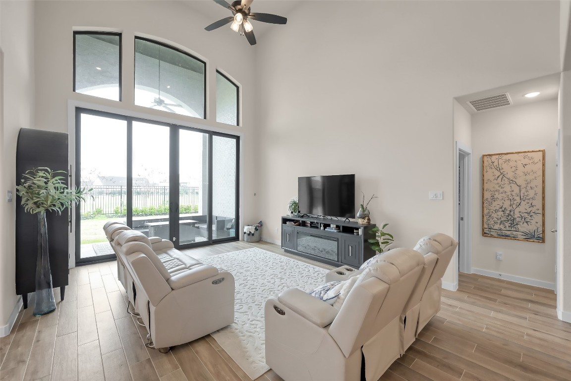 6718 Waxbill Road Katy, TX 77493 - Photo 17 of 48 a living room with furniture a flat screen tv and a large window