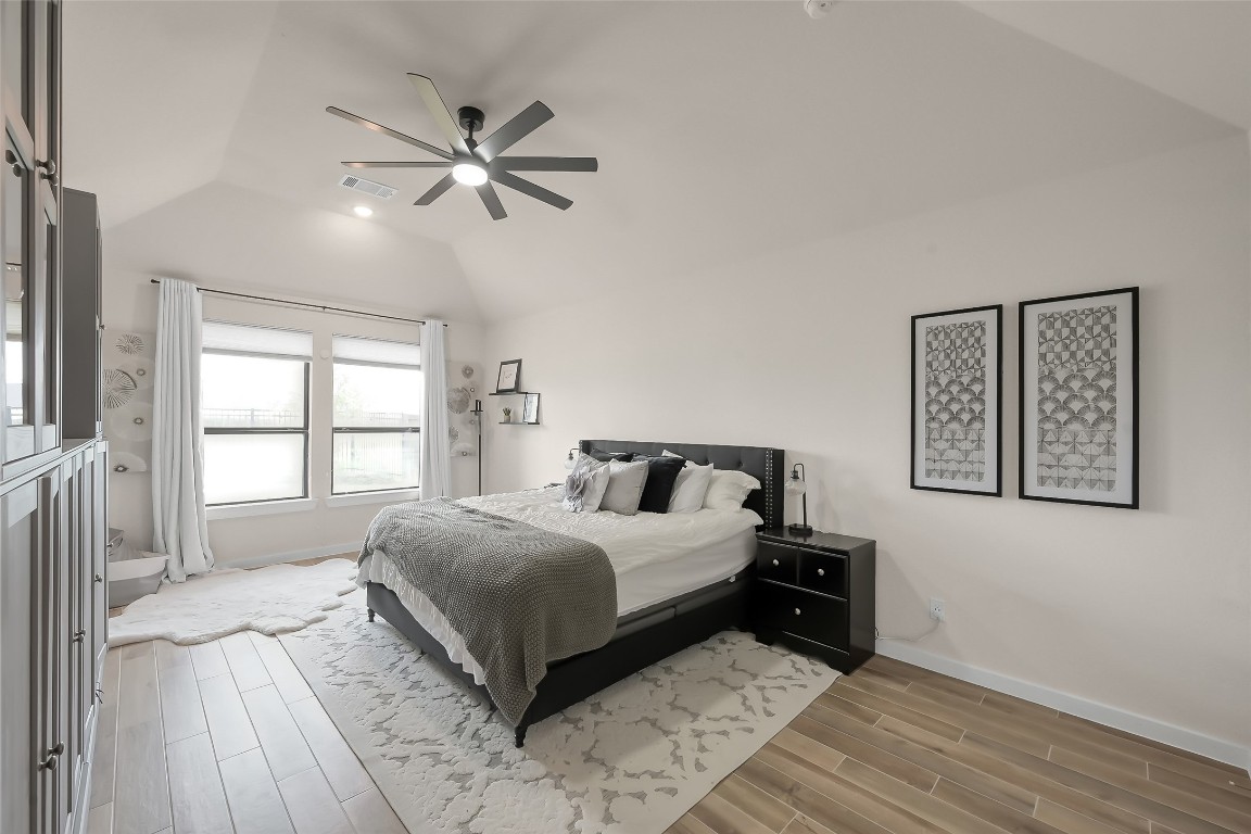 6718 Waxbill Road Katy, TX 77493 - Photo 20 of 48 a bedroom with a large bed and a window