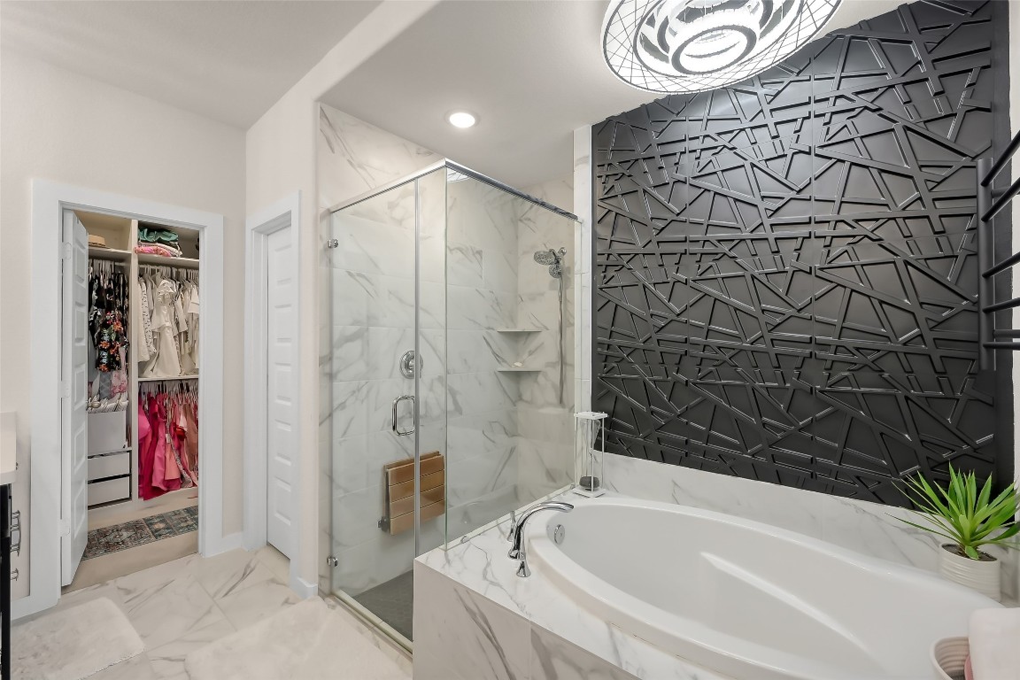 6718 Waxbill Road Katy, TX 77493 - Photo 23 of 48 a bathroom with a bathtub and shower