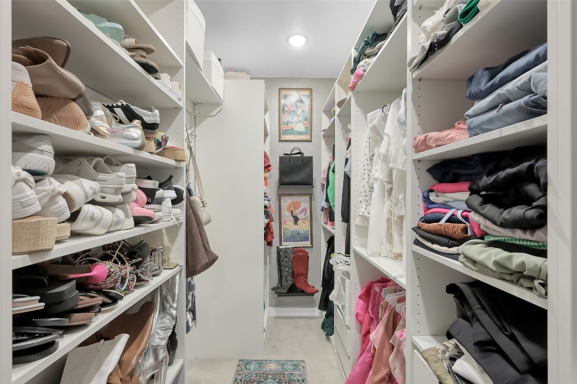 6718 Waxbill Road Katy, TX 77493 - Photo 24 of 48 a view of walk in closet with clothes and shoes