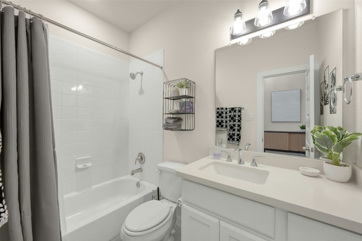 6718 Waxbill Road Katy, TX 77493 - Photo 27 of 48 a bathroom with a sink a toilet a tub and shower