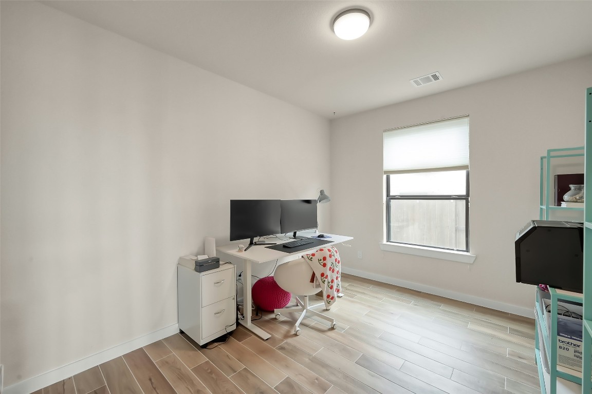 6718 Waxbill Road Katy, TX 77493 - Photo 29 of 48 a view of a workspace with furniture and a window