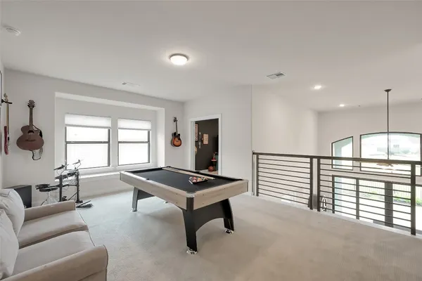 a bedroom with a bed and a flat tv screen on the dresser