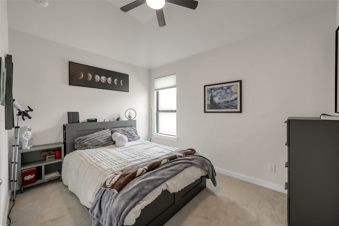 6718 Waxbill Road Katy, TX 77493 - Photo 32 of 48 a bedroom with a bed and a chandelier