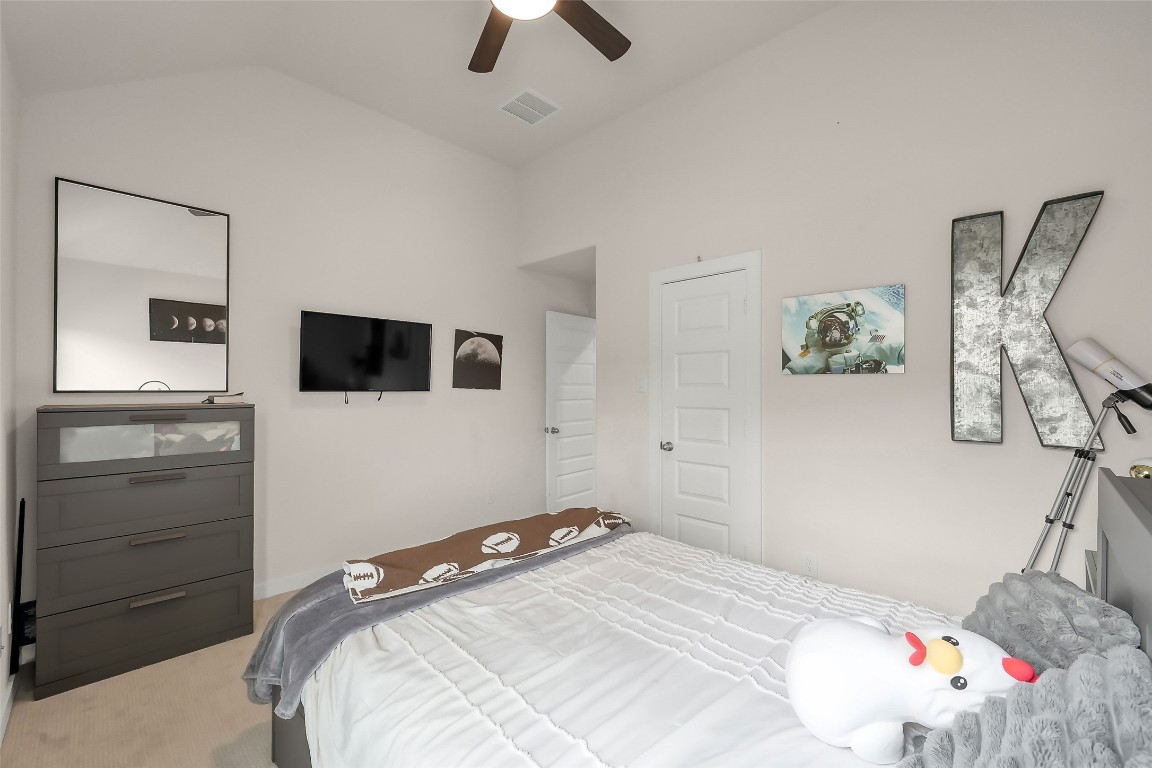 6718 Waxbill Road Katy, TX 77493 - Photo 33 of 48 a bedroom with a bed and a flat tv screen on the dresser