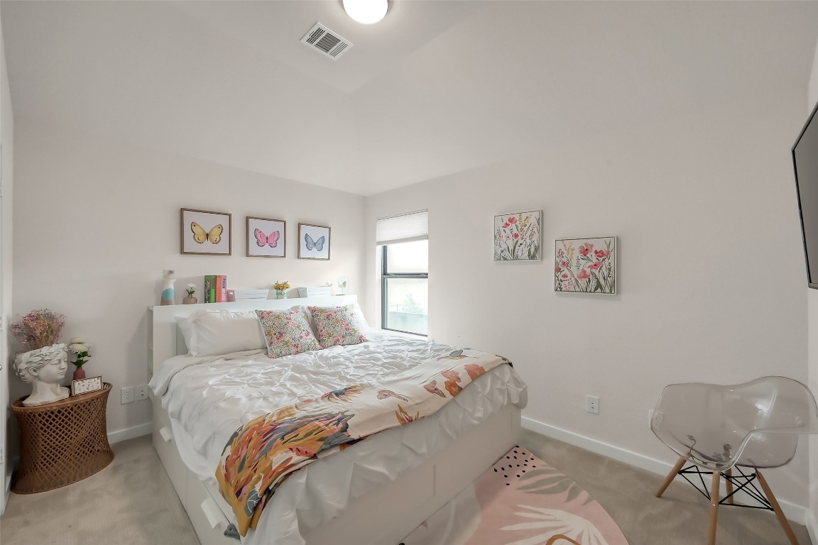 6718 Waxbill Road Katy, TX 77493 - Photo 35 of 48 a bedroom with a bed and a chair