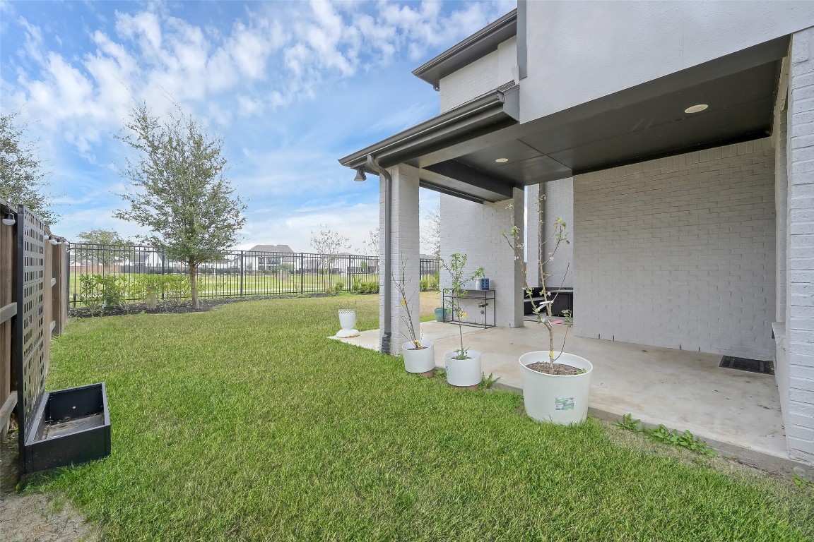 6718 Waxbill Road Katy, TX 77493 - Photo 38 of 48 a view of a backyard with table and chairs and potted plants