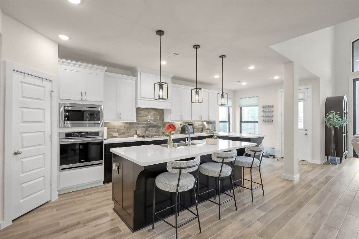 6718 Waxbill Road Katy, TX 77493 - Photo 9 of 48 a large kitchen with a table and chairs