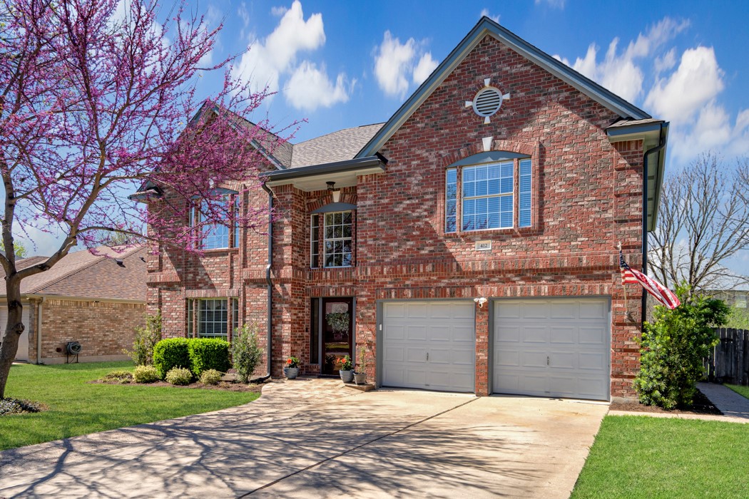 412 Derby Lane Georgetown, TX 78626 - Photo 1 of 37 a front view of a house with a garden