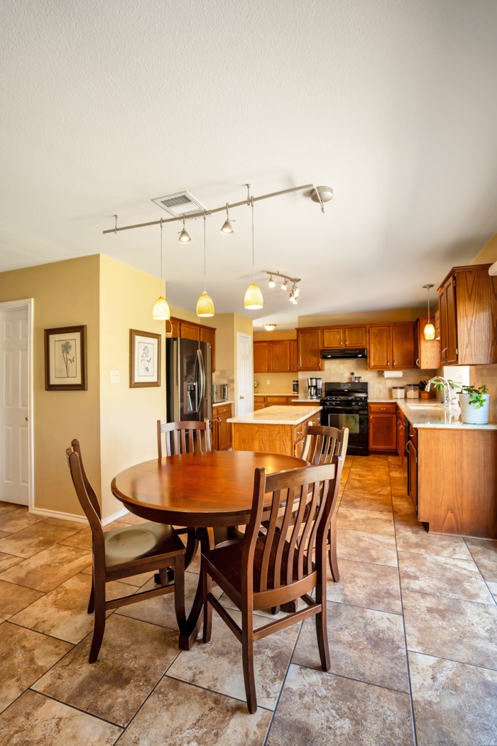 412 Derby Lane Georgetown, TX 78626 - Photo 13 of 37 a dining room with a wooden table and chairs