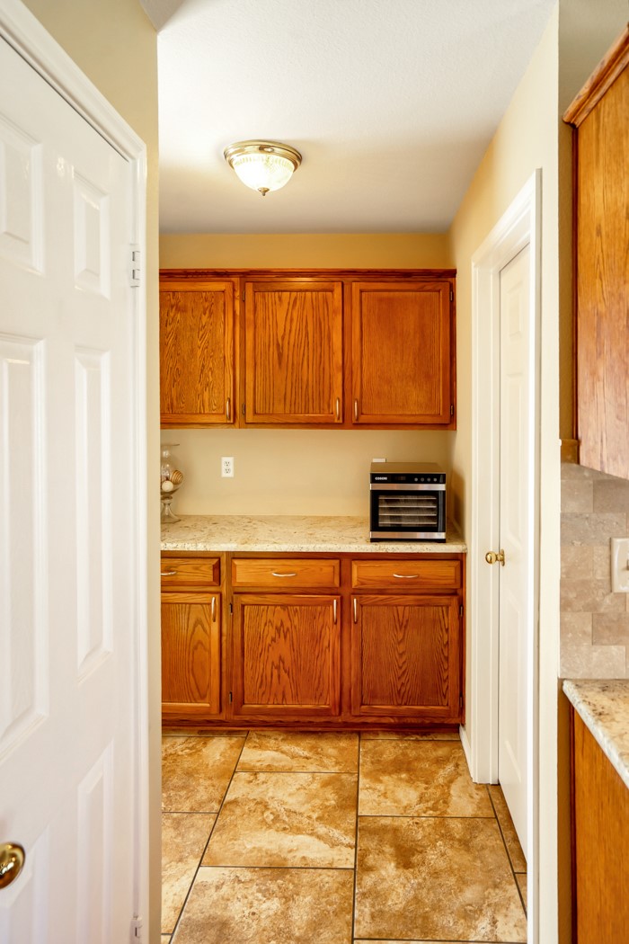 412 Derby Lane Georgetown, TX 78626 - Photo 17 of 37 a kitchen with granite countertop a refrigerator and a sink