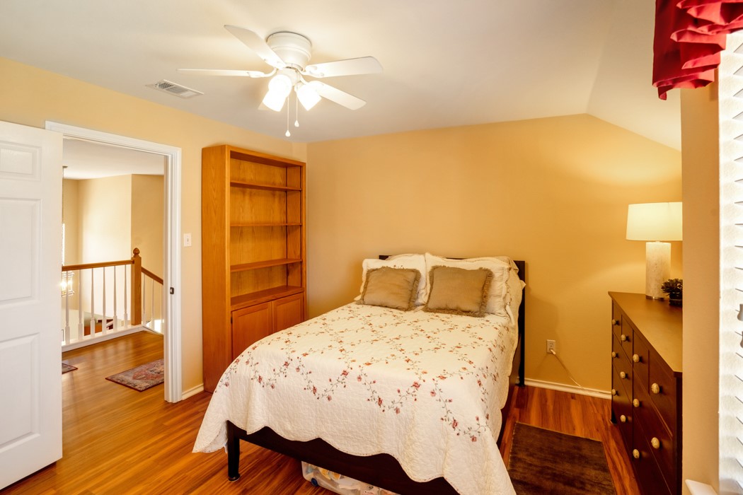 412 Derby Lane Georgetown, TX 78626 - Photo 27 of 37 a bedroom with a bed and wooden floor