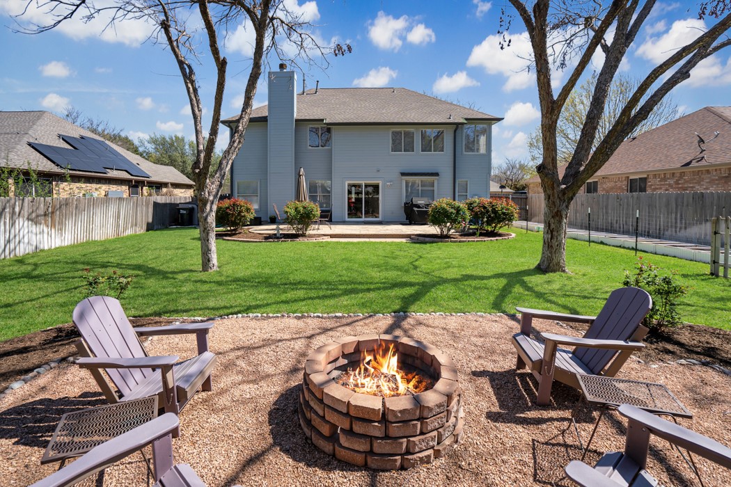 412 Derby Lane Georgetown, TX 78626 - Photo 35 of 37 a view of a patio with a table chairs and a fire pit