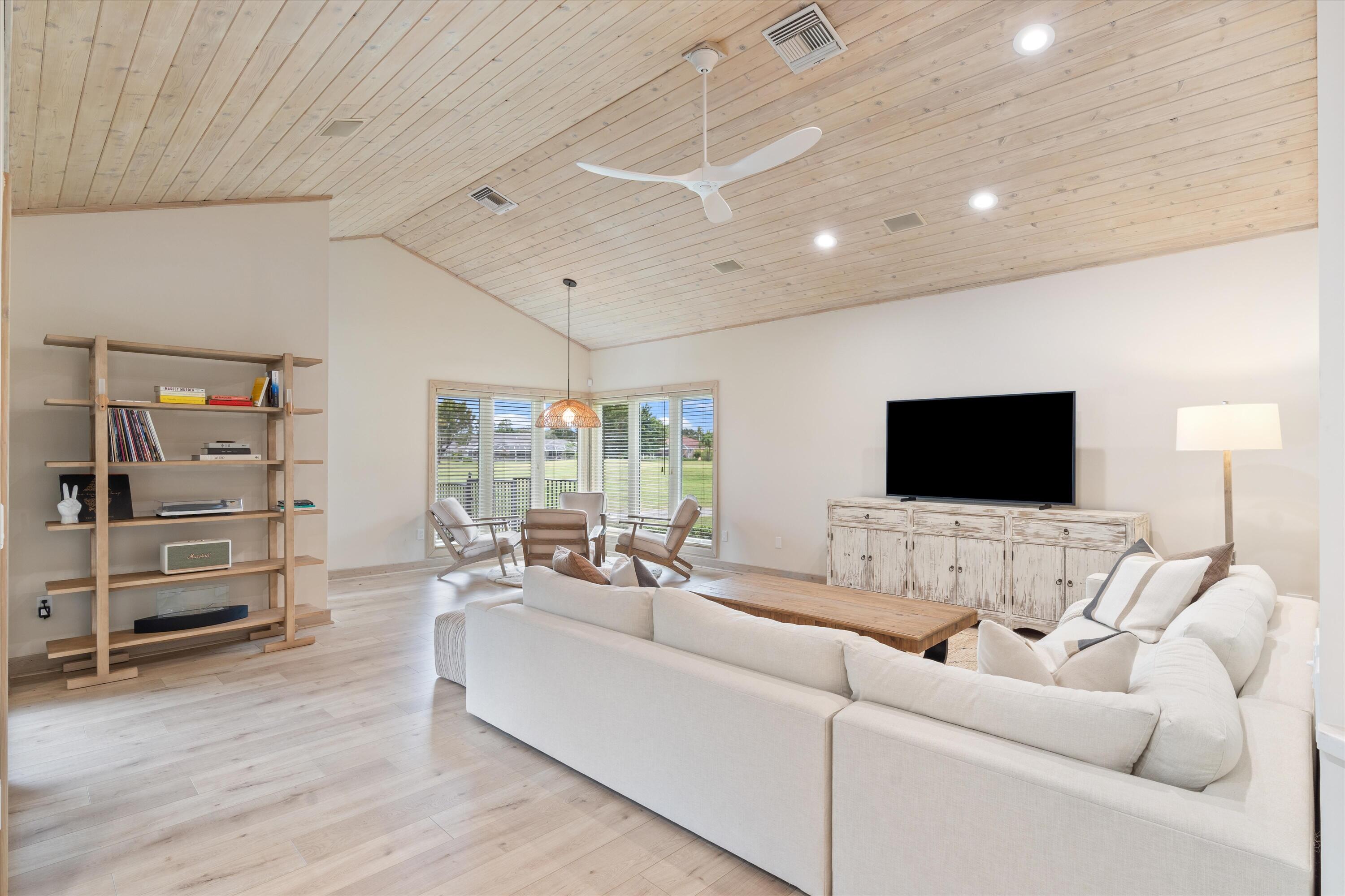 121 Turnberry Drive Atlantis, FL 33462 - Photo 11 of 47 a living room with furniture and a flat screen tv