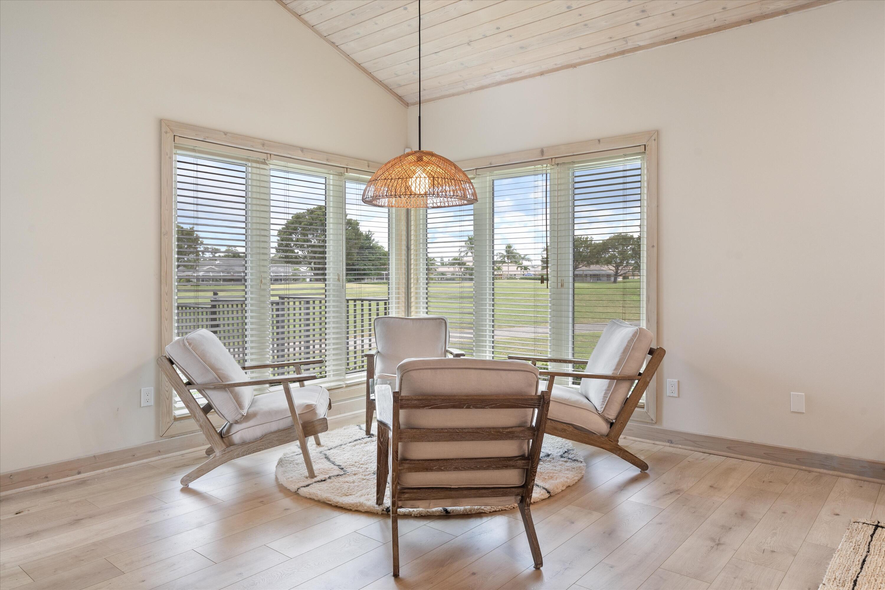 121 Turnberry Drive Atlantis, FL 33462 - Photo 13 of 47 a living room with furniture and a chandelier