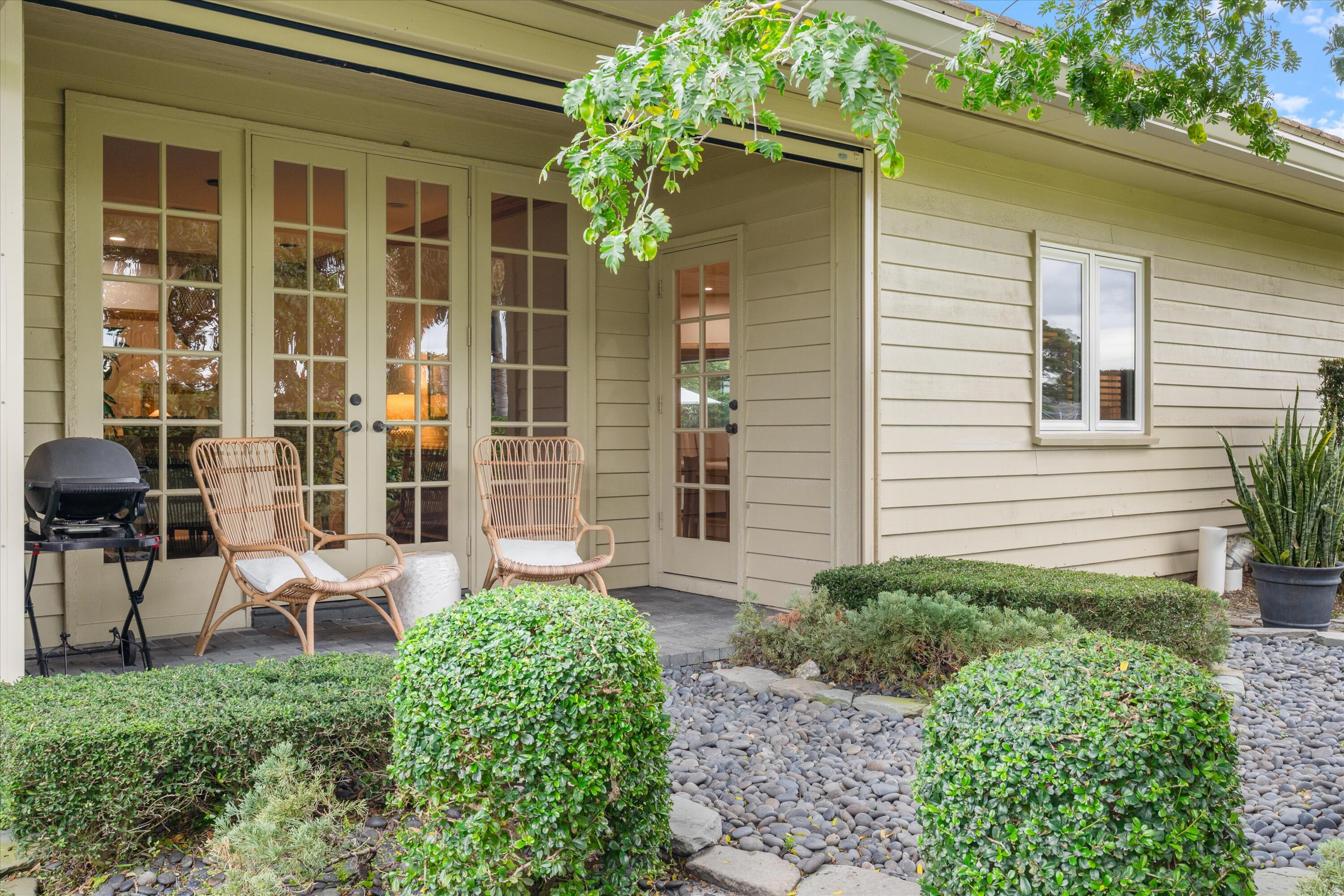 121 Turnberry Drive Atlantis, FL 33462 - Photo 17 of 47 a view of a chair and table in front of house