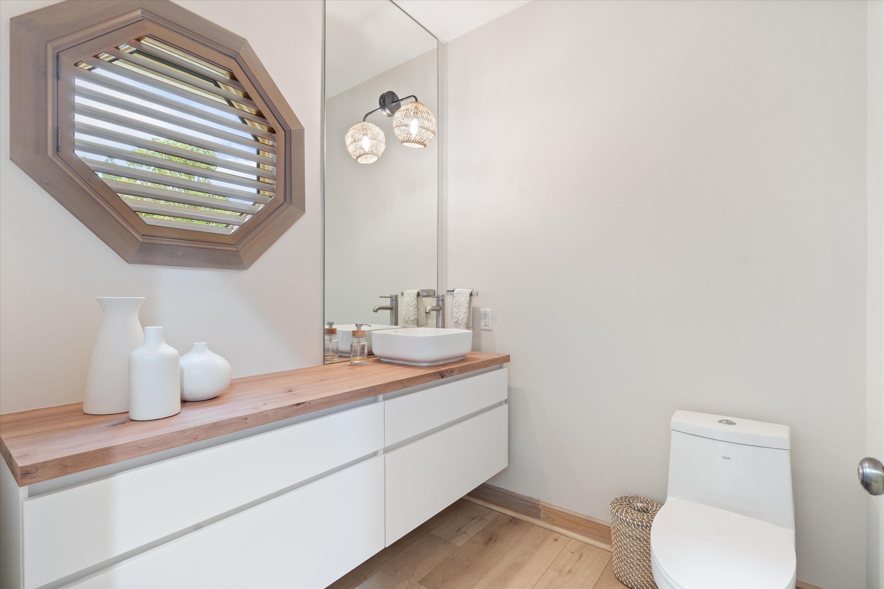 121 Turnberry Drive Atlantis, FL 33462 - Photo 18 of 47 a bathroom with a sink a toilet and mirror