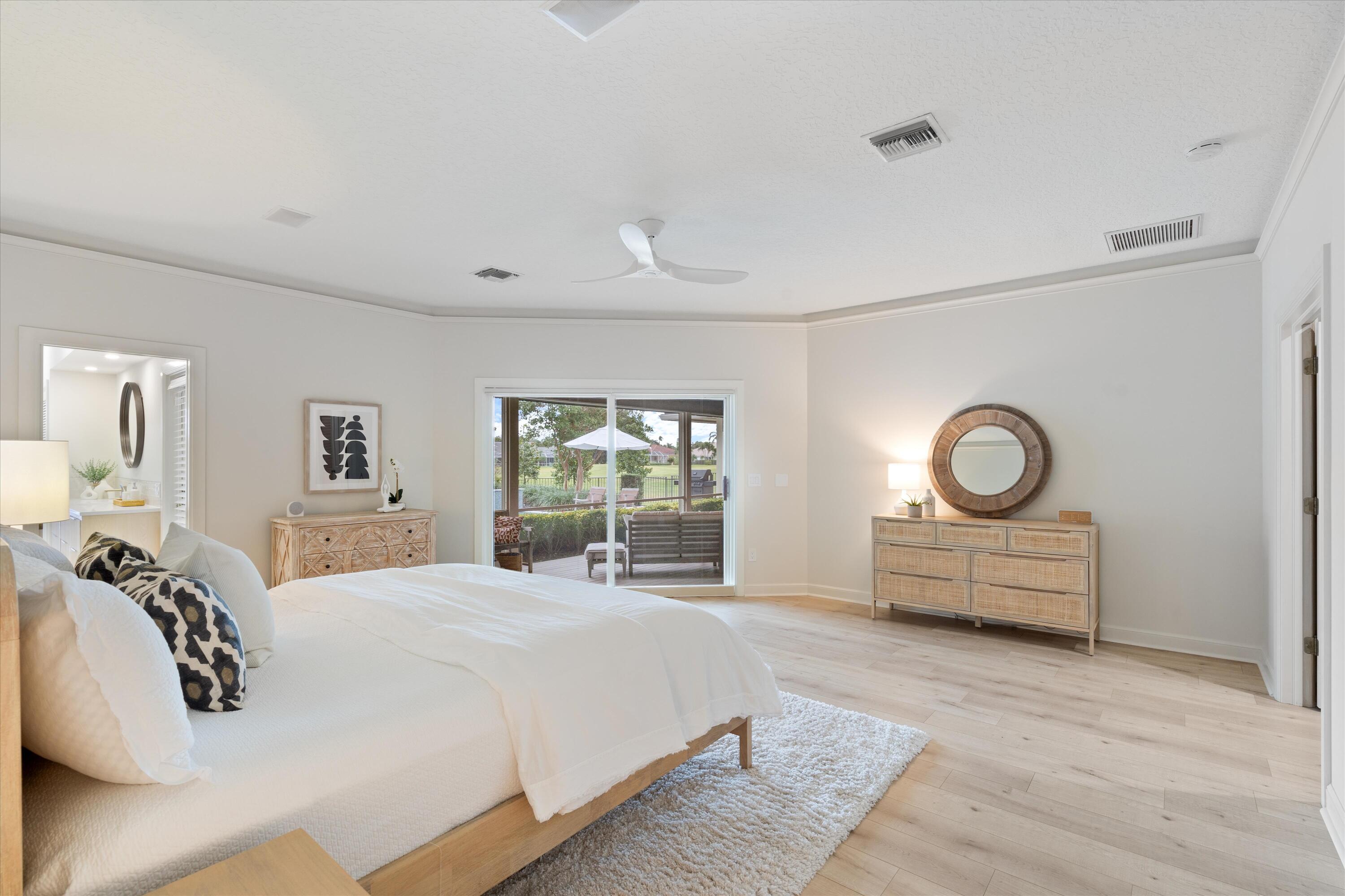 121 Turnberry Drive Atlantis, FL 33462 - Photo 20 of 47 a bedroom with a bed and a large window