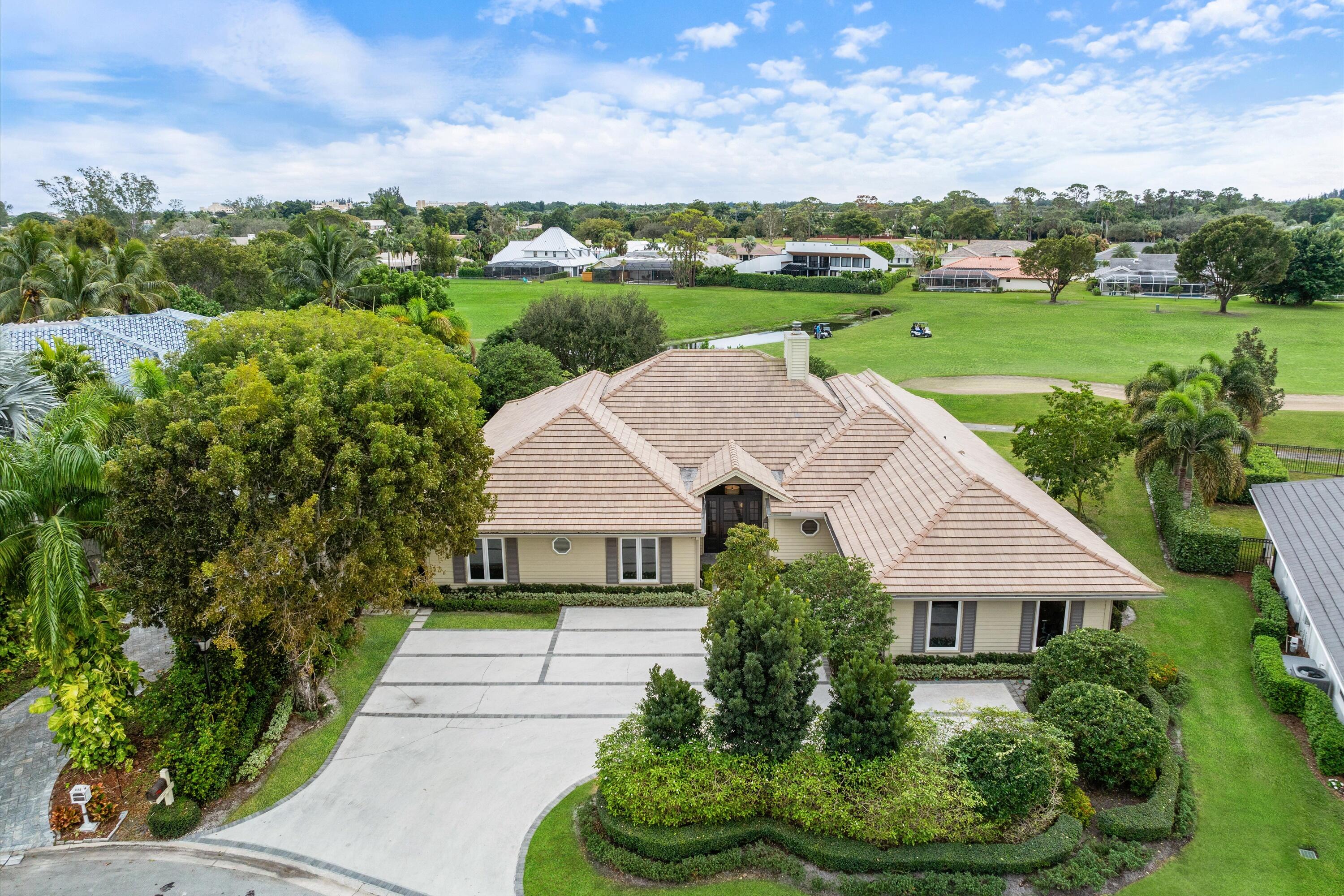 121 Turnberry Drive Atlantis, FL 33462 - Photo 2 of 47 an aerial view of a house with big yard