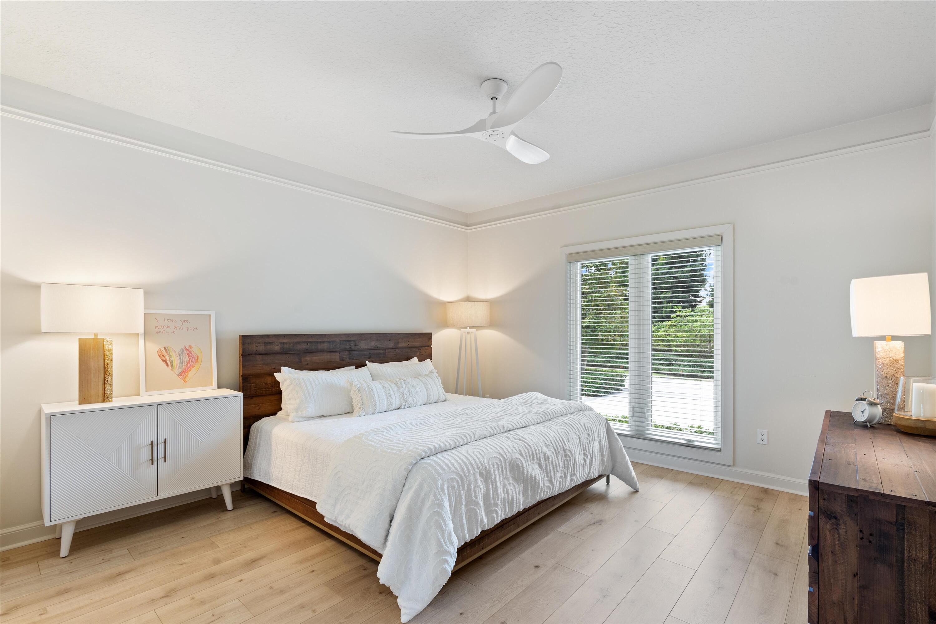 121 Turnberry Drive Atlantis, FL 33462 - Photo 24 of 47 a bedroom with a large bed and a lamp on table