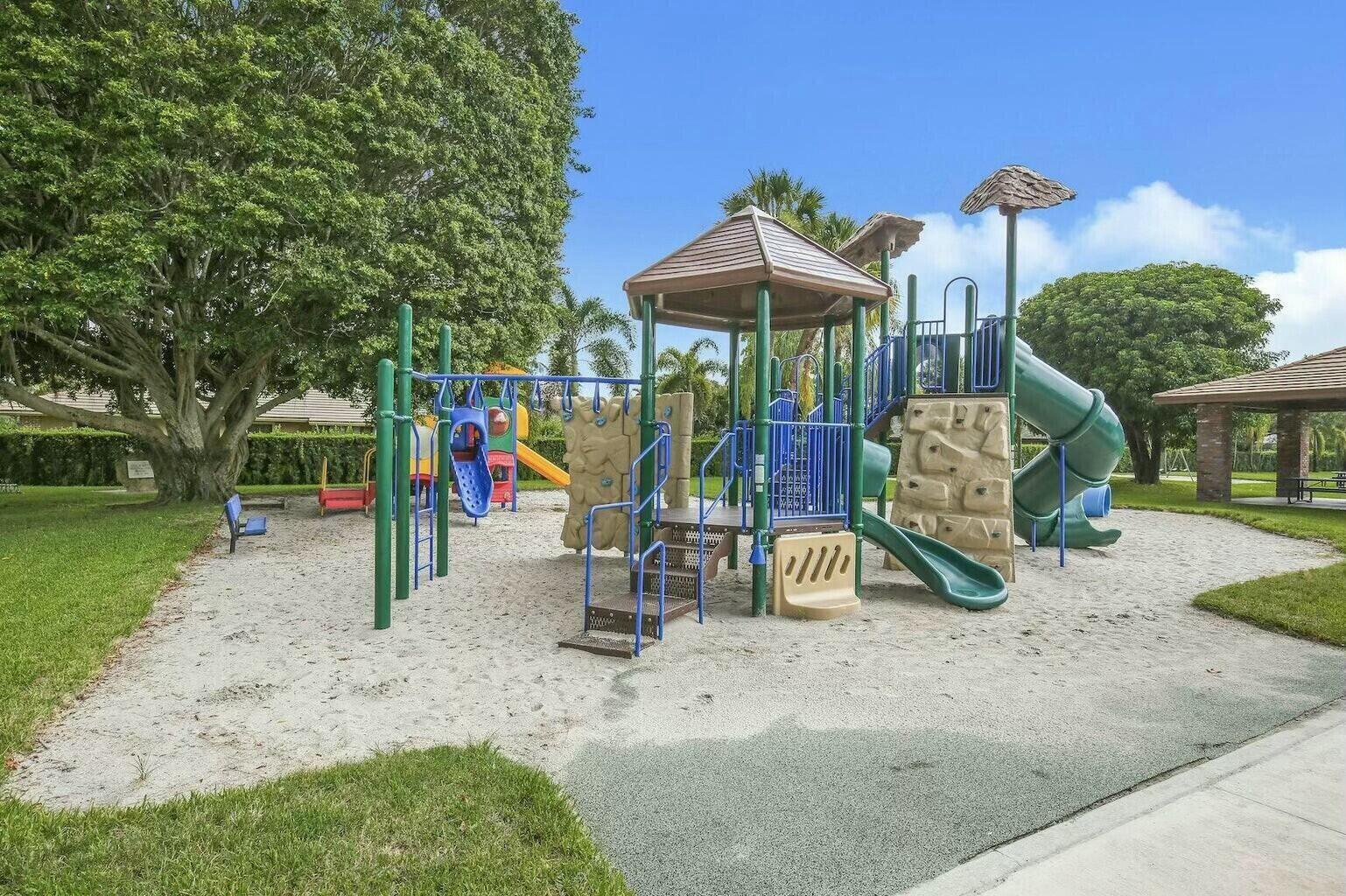 121 Turnberry Drive Atlantis, FL 33462 - Photo 45 of 47 a view of a park with swings