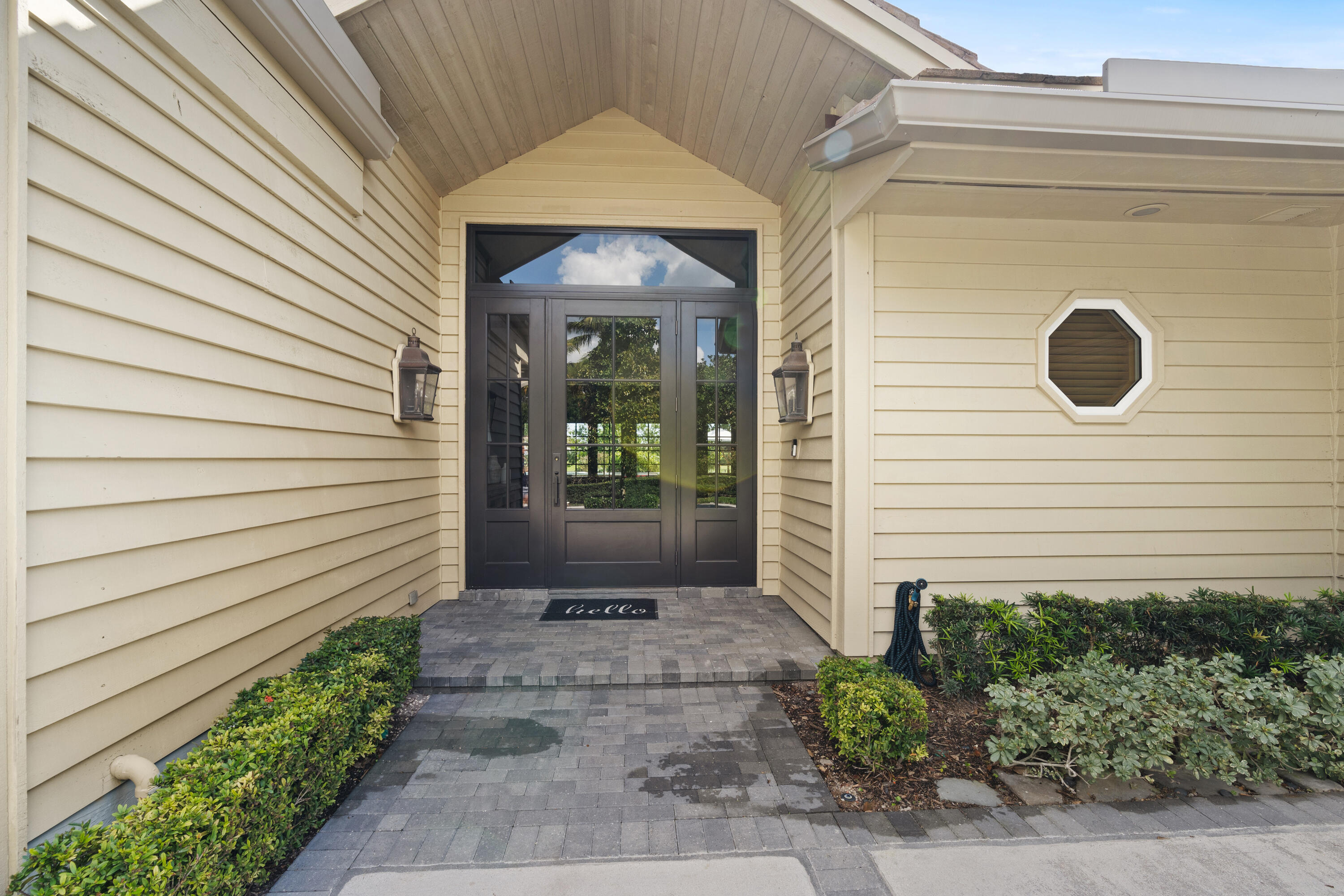 121 Turnberry Drive Atlantis, FL 33462 - Photo 5 of 47 a view of a door of the house with potted plants