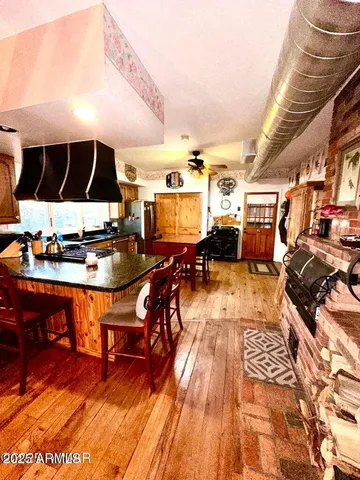 a outdoor kitchen with granite countertop lots of appliances