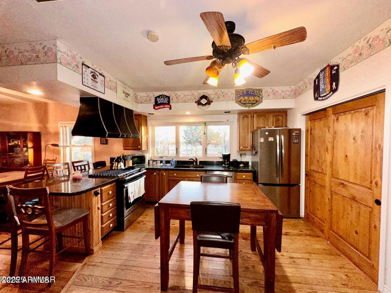 280 County Road Snowflake, AZ 85937 - Photo 15 of 45 a dining room with stainless steel appliances kitchen island granite countertop furniture and a large window