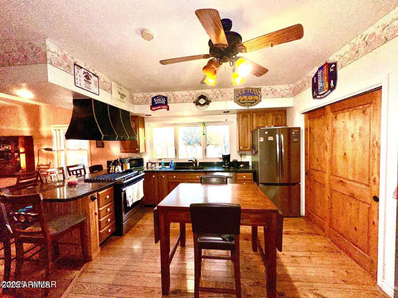 280 County Road Concho, AZ 85924 - Photo 20 of 46 a kitchen with stainless steel appliances kitchen island granite countertop a table and chairs in it