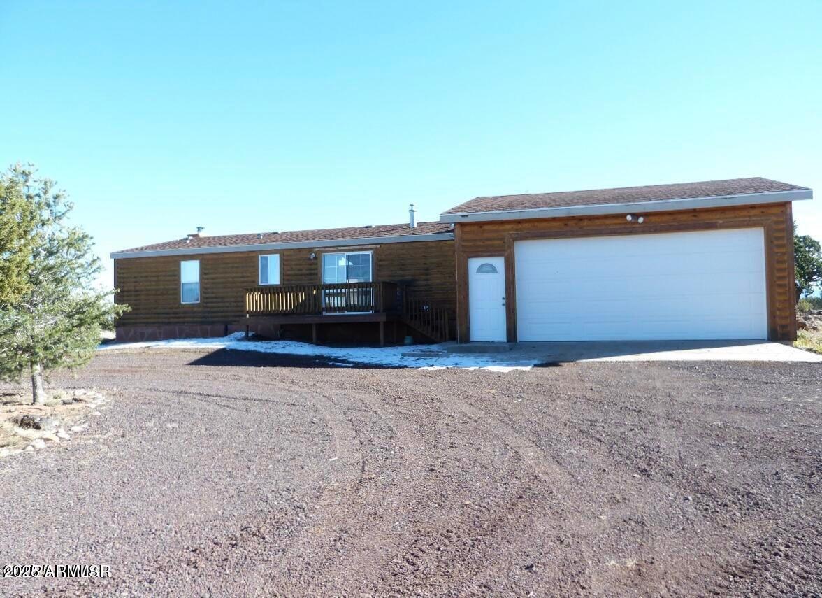 280 County Road Concho, AZ 85924 - Photo 41 of 46 a front view of a house with a yard and garage