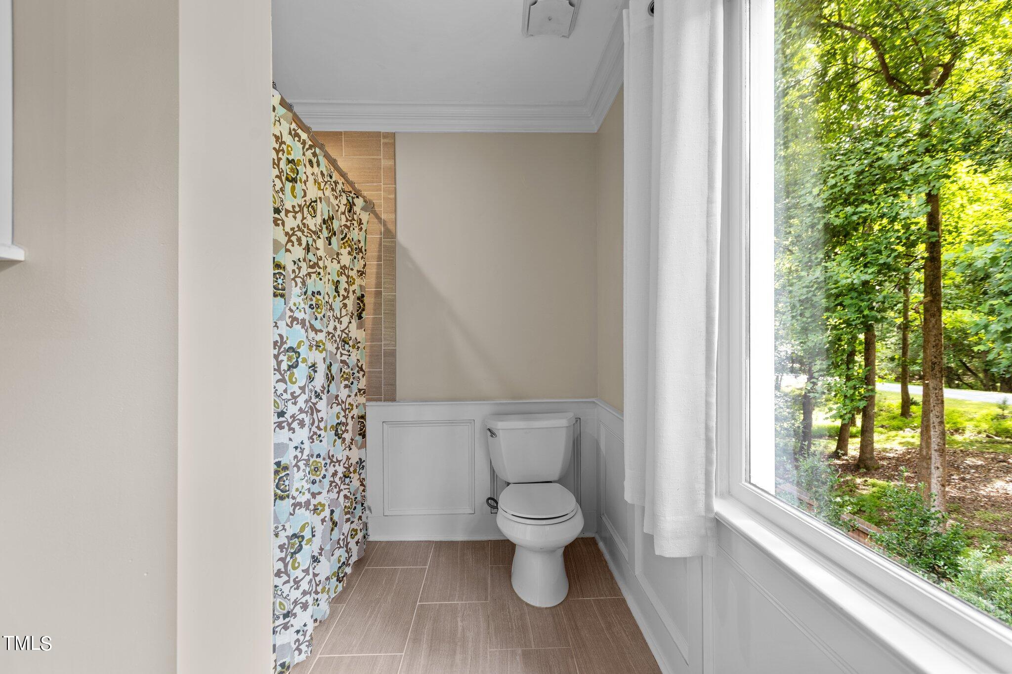 300 Key Court Raleigh, NC 27614 - Photo 45 of 85 a white toilet sitting next to a shower curtain