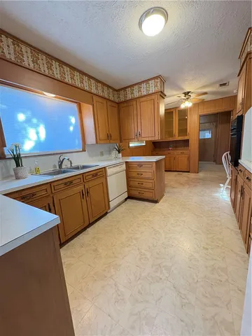 a kitchen with stainless steel appliances granite countertop a stove a sink dishwasher and a refrigerator