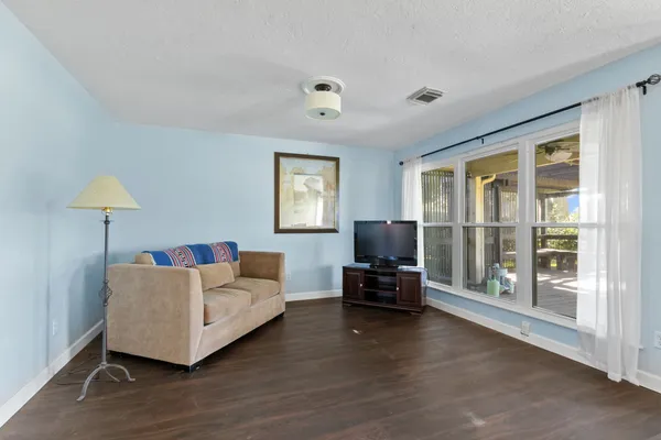 a living room with furniture and wooden floor