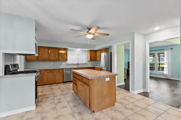a kitchen with stainless steel appliances granite countertop a sink and cabinets
